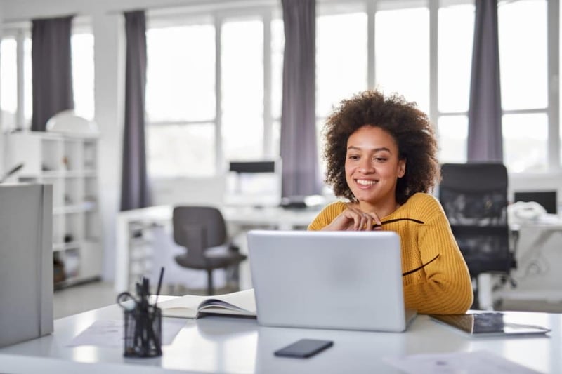 smiling businesswoman working on laptop