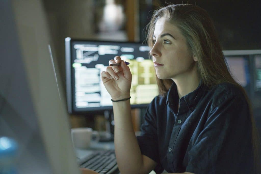 woman sat at her desk looking at monitor