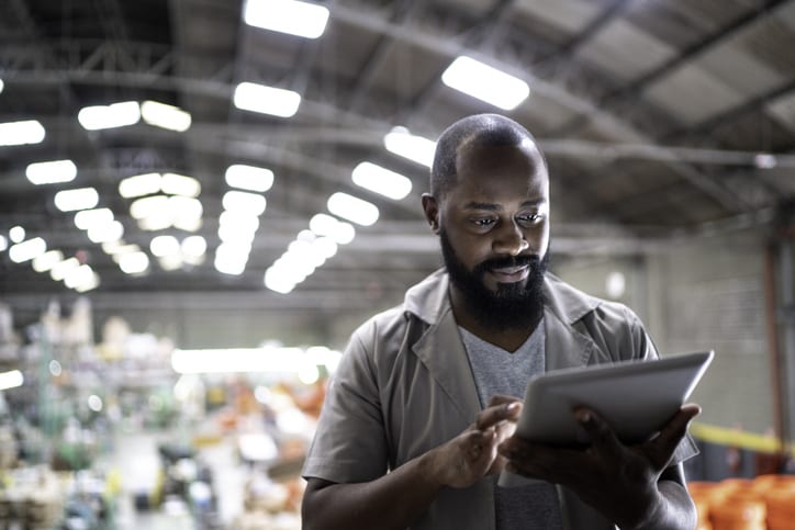 warehouse manager looking at tablet