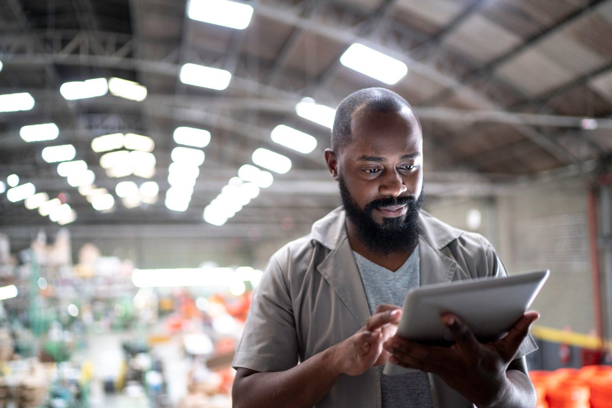 Focused manager using digital tablet in a factory