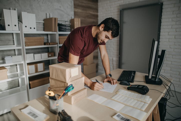 man filling out a delivery form