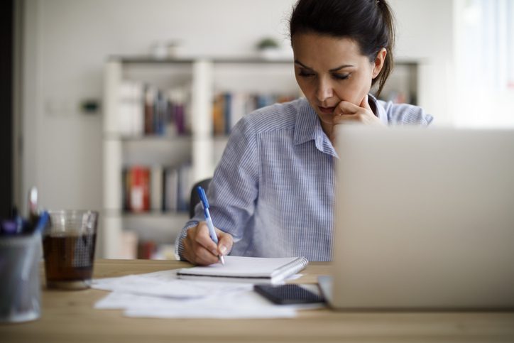 woman making notes on pad