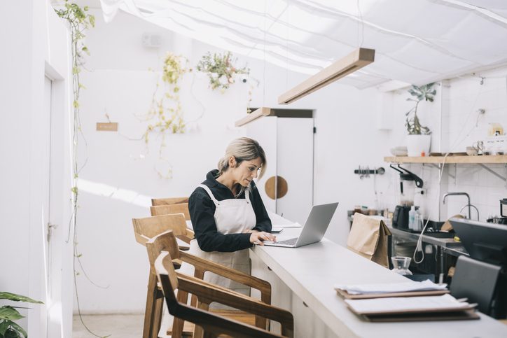 cafe manager on laptop