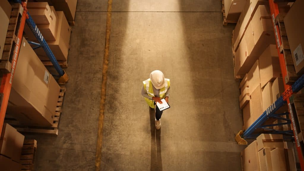 top-down view of warehouse worker checking stock