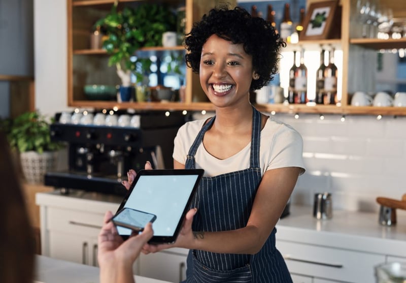 barista taking payment from customer