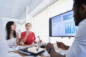 Businesswoman discussing with her colleagues during meeting in office