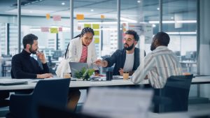 Diverse Modern Office: Successful Motivated Black Businesswoman Leads Meeting, talks of Company Growth. Digital Entrepreneurs Work on e-Commerce Project. Multi-Ethnic Creatives Brainstorm Strategy