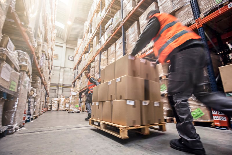warehouse worker pushing dolly