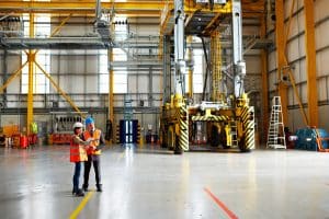 Shot of two warehouse workers talking together over a digital tablet