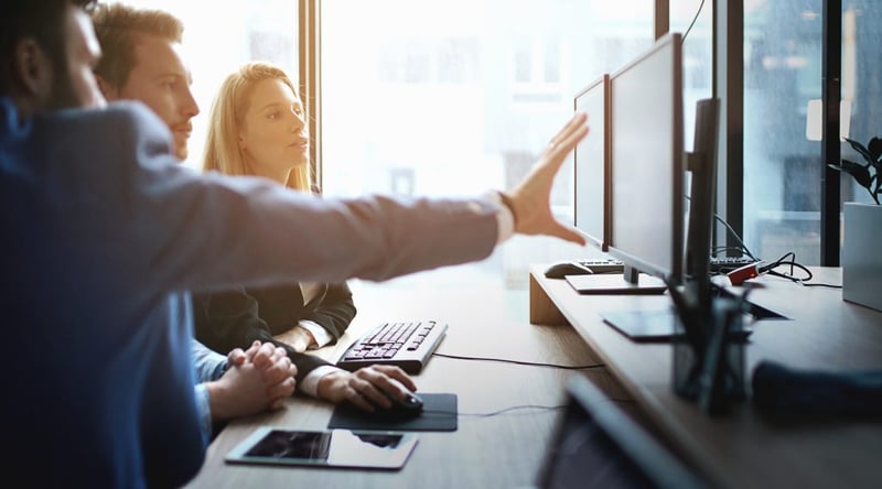 business colleagues looking at computer monitor