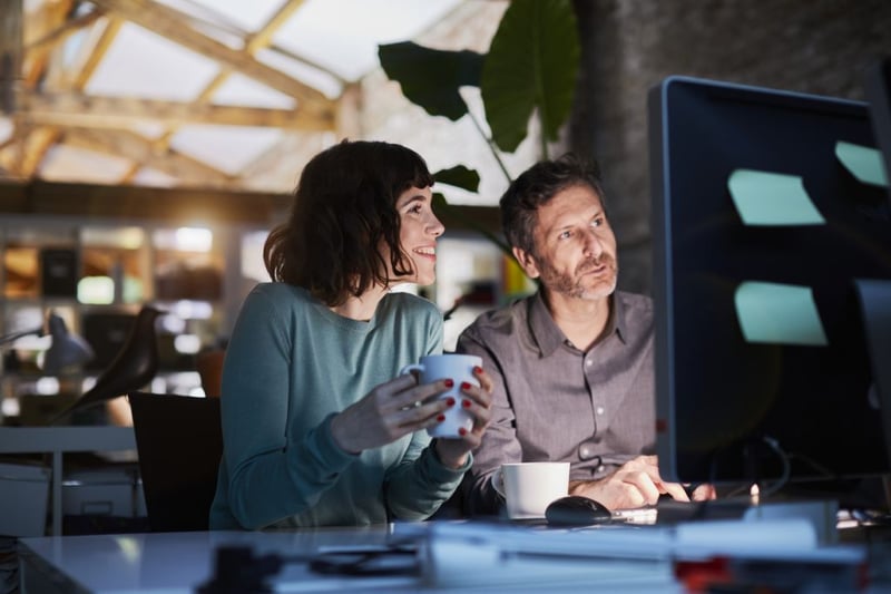 colleagues looking at work on computer