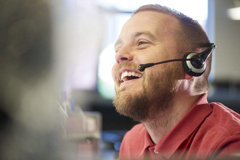 laughing man working talking through headset