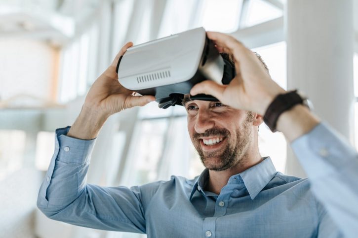 smiling man using virtual reality headset